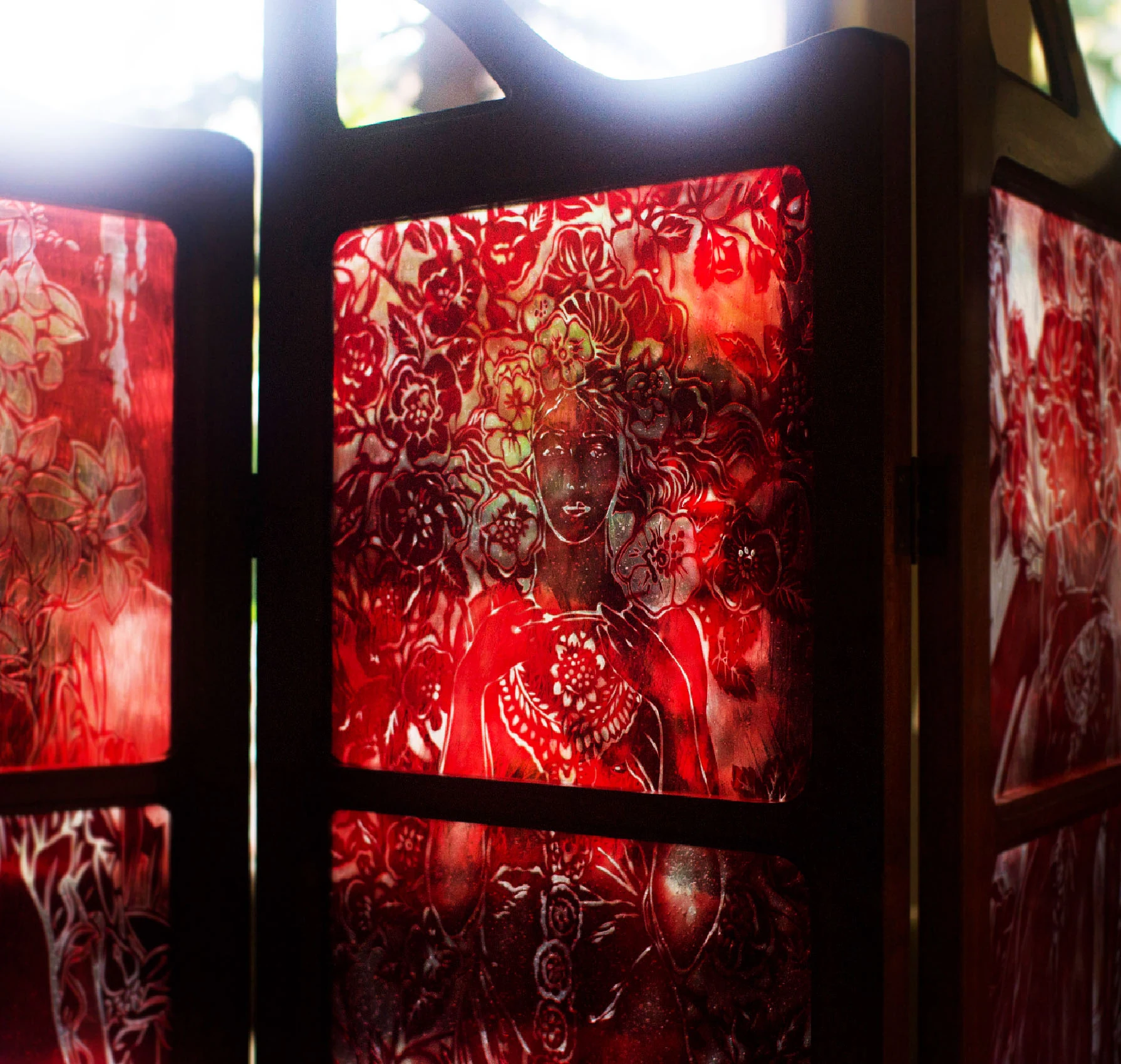 Red blown flashed-glass screen with a figure and floral motifs